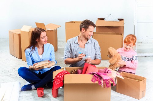 Professional movers handling house removals in a Somers Town property