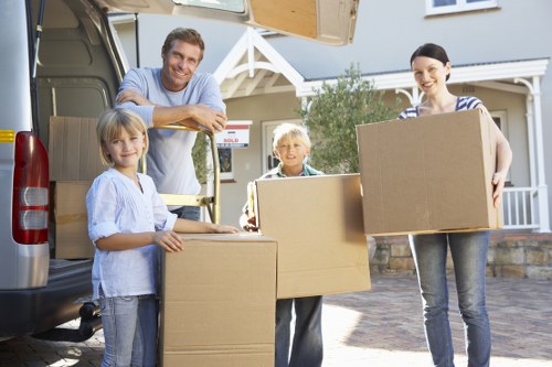 Professional movers handling boxes and furniture for a local relocation